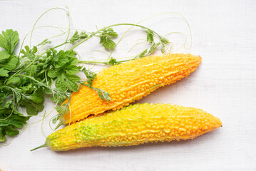 Bitter melon or bitter gourd (yellow) ready for seeds extraction.