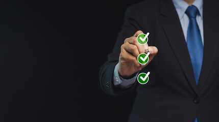 Fototapeta premium Businessman uses a pen to tick the correct sign in the checkbox for the quality document control checklist