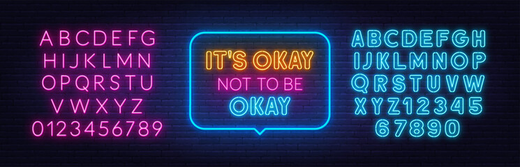 Its Okay Not To Be Okay neon lettering on brick wall background.