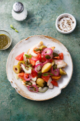 Healthy potato salad with tomatoes and olives