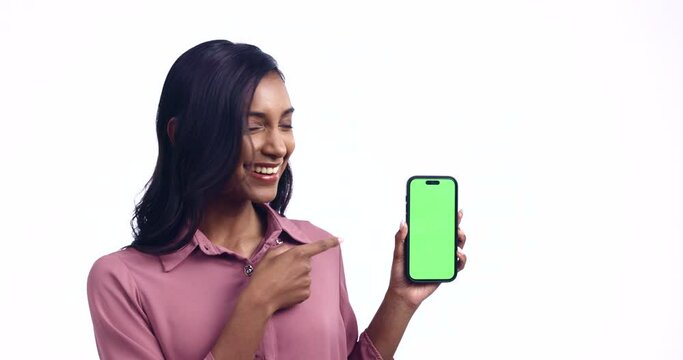 Woman, thumbs up and green screen phone in studio for review, feedback and happy by white background. Isolated girl, smartphone and vote with smile, chromakey mockup space and promo for brand logo
