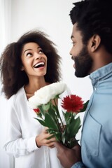 shot of a young woman being surprised by her boyfriend with flowers