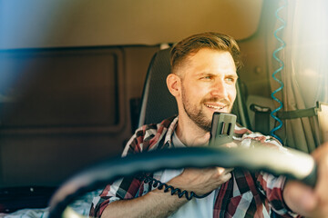 Semi Truck Driver Making Conversation with Other Truck Drivers Through CB Radio.