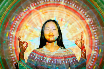 Asian woman meditating near mandala