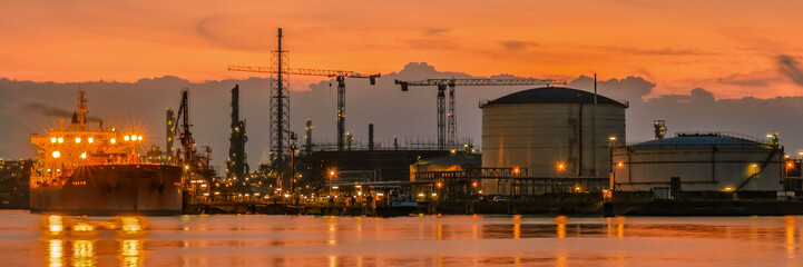 Antwerp Harbor Belgium Sunset with a large oil tanker at an oil gas LPG terminal 