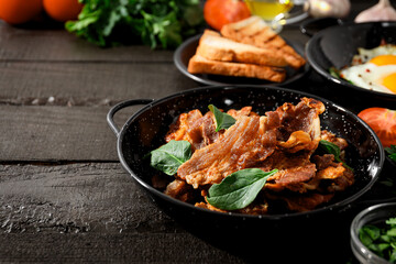 Tasty breakfast and delicious meat food concept - fried bacon