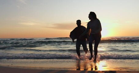 Holding hands, sunset and couple walking on a beach running on vacation or holiday together for love or care. Silhouette, man and woman with happiness on anniversary with travel freedom at ocean - Powered by Adobe
