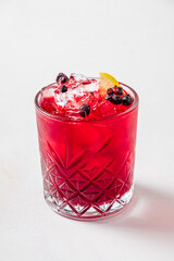 cocktail with blueberries and lemon