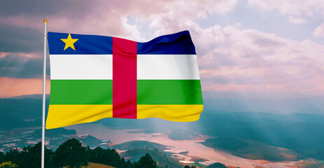 Central African Republic national flag cloth fabric waving on beautiful grey sky Background.