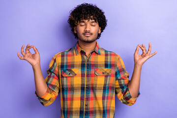 Fototapeta na wymiar Photo of nice peaceful calm young man closed eyes arms fingers meditate isolated on violet color background