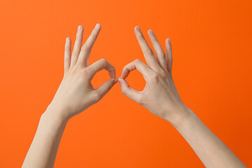 Female hand shows OK gesture. OK hand sign