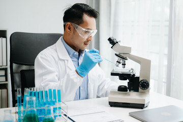 Modern medical research laboratory. male scientist working with micro pipettes analyzing...