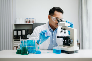 Modern medical research laboratory. male scientist working with micro pipettes analyzing...