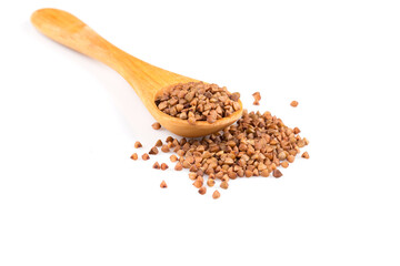 Uncooked buckwheat on wooden spoon