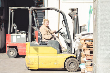 Woman driving a forklift outside a factory