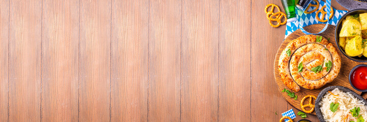  Oktoberfest munich traditional festival menu foods - bavarian sausages, pretzels, potato, sauerkraut, beer bottle and mug,  Background flyer for Oktoberfest invitation on old wooden table