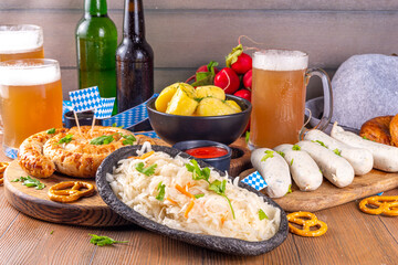  Oktoberfest munich traditional festival menu foods - bavarian sausages, pretzels, potato, sauerkraut, beer bottle and mug,  Background flyer for Oktoberfest invitation on old wooden table