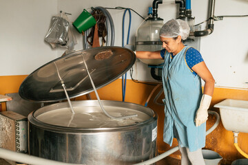 Professional female worker checking metal machine