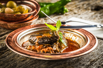 Delicious eggplant with mince on a bronze plate
wooden background