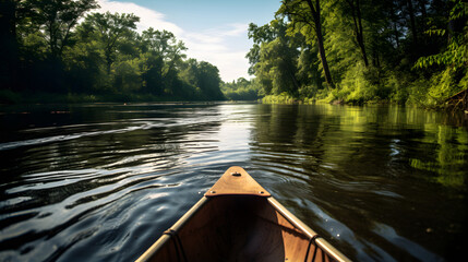Shot from inside a canoe, capturing the serene view of a calm river surrounded by nature