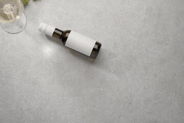 Mini Bottle of white wine with a label, grapes and a cork. Wine bottle mockup.