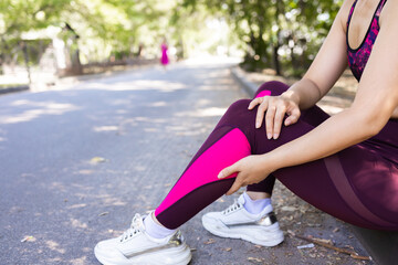 Young adult woman with muscle pain while running. A runner has a sore foot due to plantar...