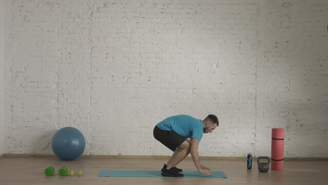 Man fitness trainer in sportswear doing burpee with high jumps exercise for online class at home studio. HDR BT2020 HLG Material
