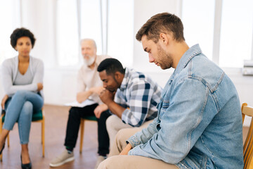 Side selective focus view of pensive black male talking complaints discuss life problems grief in group therapy session. Concept of mental health, psychotherapy, social issues, support, assistant.