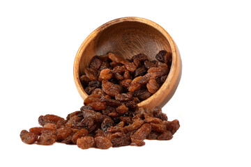Sweet raisins from a wooden bowl spill out on a white background.