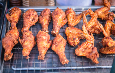 Battered chicken drumsticks and wings for sale on roadside carts near Pattaya beach, Thailand.