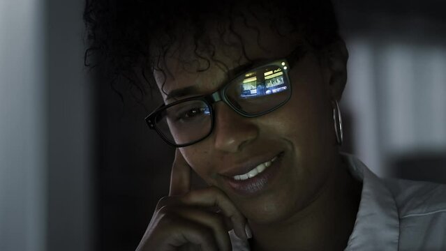 
Close up Young Woman Eye Glasses Reflection. African American Female Looking at Electronic Device with Animated Videos Reflected in her Eyeglasses. All Videos Included in my Portfolio.