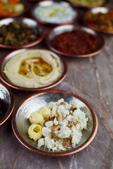 Walnut curd cheese appetizer in a bronze bowl with other appetizers