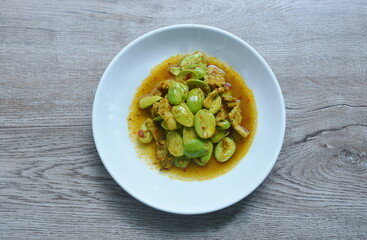 spicy fried pork with flat bean in shrimp paste curry Thai southern food on plate 