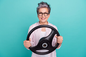 Photo of woman professional uber taxi holding steering wheel teach safety driving road automobile isolated on aquamarine color background