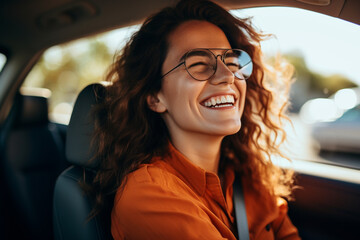 Joyful Brunette Behind the Wheel: Portrait of a Successful and Smiling Female Driver - obrazy, fototapety, plakaty