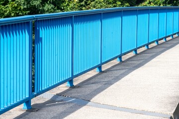 Fototapeta na wymiar blue bridge railing in the sun