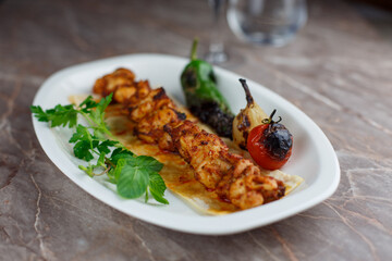 Delicious grilled skewer chicken with vegetables on a plate