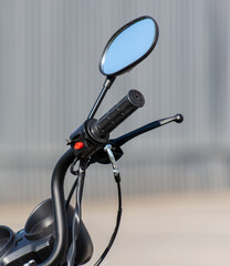 Motorcycle steering wheel mirror. Close-up