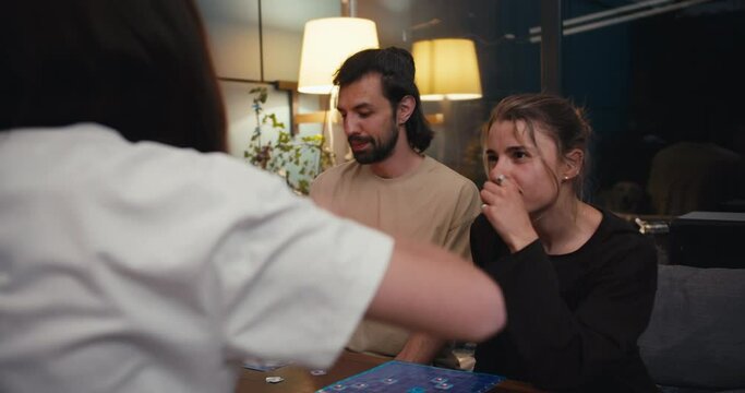 The guy the girl lost the board game and that's why they are sad. Their opponent is very happy and waving his arms