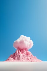 A pink volcano with a white cloud on top against blue sky background. Minimal vivid pastel colored imaginary landscape concept.