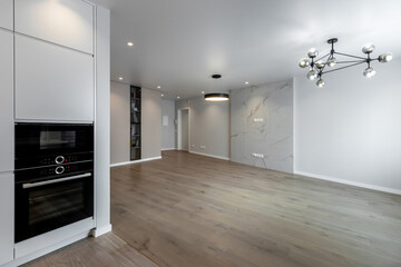 The interior of an empty modern apartment in bright colors immediately after renovation