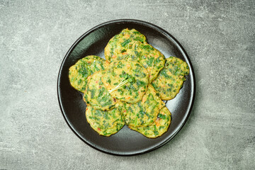 buchujeon, korean Chive Pancake, To prepare this dish, chive, julienned carrot, and green pepper are mixed with flour and pan-fried in a flat, round, pancake-like shape. 