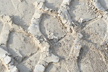 Tracks of heavy machinery in the sand