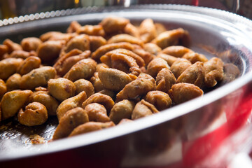 Fried fish starters at a street food stall in the city of Bangkok in Thailand..