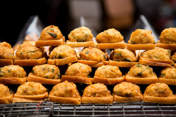 Fried fish starters at a street food stall in the city of Bangkok in Thailand..
