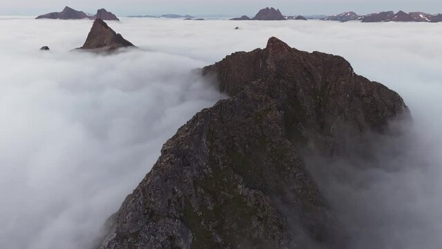Highland Wonders: Aerial Vistas of Segla's Craggy Mountains Above Clouds