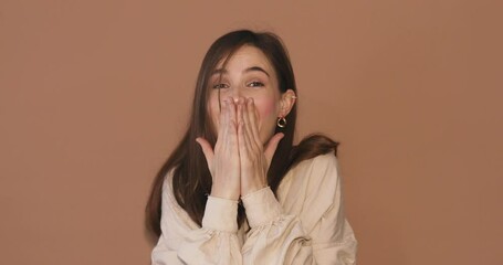 Amazed excited woman hairstyle in beige shirt open face in surprise looking at camera with big eyes, shocked. Indoor studio shot isolated on beige background. Oh my god wow! Wow, it is awesome.