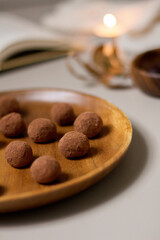 Chocolate truffles covered with cocoa powder. Gray background. Delicious dessert concept.