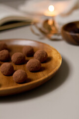 Chocolate truffles covered with cocoa powder. Gray background. Delicious dessert concept.