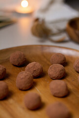 Chocolate truffles covered with cocoa powder. Gray background. Delicious dessert concept.